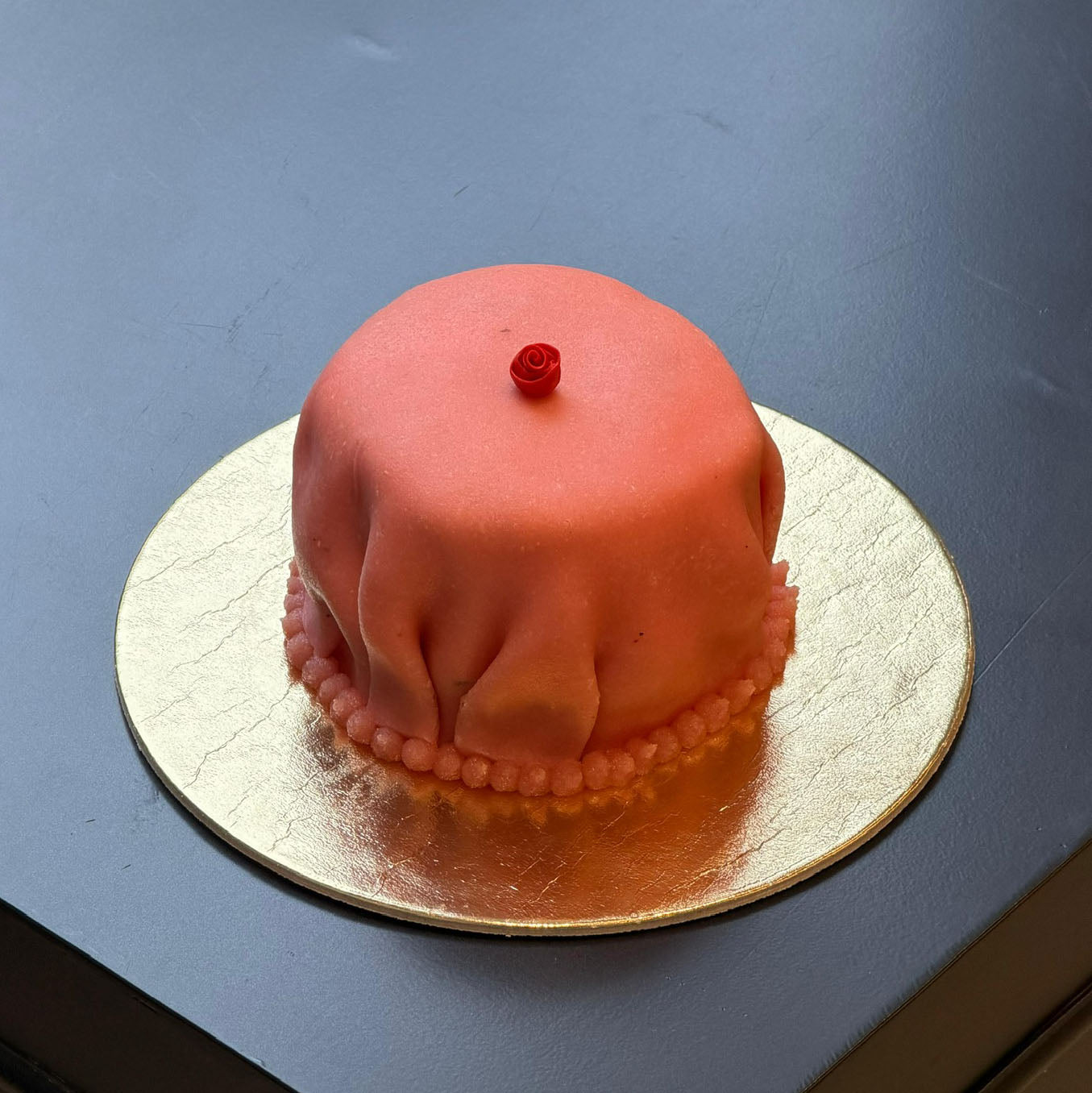Princess mini cake covered in homemade marzipan with diplomat cream and raspberry coulis.